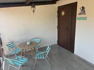 a table and chairs in a room with a door at Mermaid Cove in Sukošan