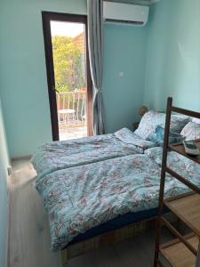 a bedroom with a bed and a door to a patio at Mermaid Cove in Sukošan