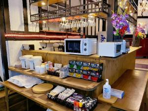 a restaurant with a counter with food and a microwave at Hakuba Sun Valley Hotel Annex - Vacation STAY 90337v in Iida +8 photos