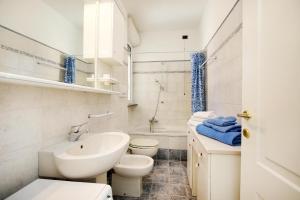 a white bathroom with a sink and a toilet at WIRO-fontana-21 sole mare e relax in Marina dʼAndora +16 photos