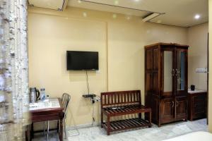 a room with a bench and a tv on the wall at The Bayan Elegance Hotel in Jaipur +13 photos