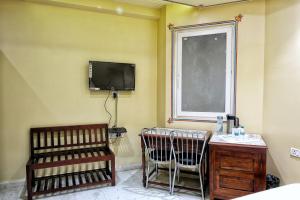 a room with a desk and a tv and a chair at The Bayan Elegance Hotel in Jaipur