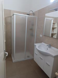 a bathroom with a shower and a white sink at Casa Vacanze Salento in Matino