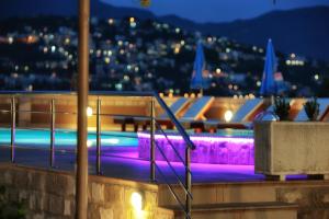 a swimming pool at night with lights at Apartments Obala - Katić in Herceg-Novi