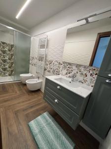 a bathroom with a sink and a toilet and a mirror at Belvedere Dei Trabocchi in Ortona