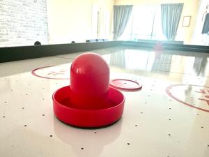 a red hat sitting on the floor of a room at 12pax 3-Bedroom l Seaview l Georgetown l Gleneagles l Mansion One in George Town