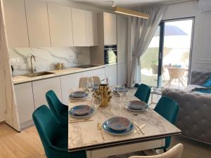 a kitchen with a table with plates and wine glasses at Luxury Villa Olga in Biograd na Moru +23 photos