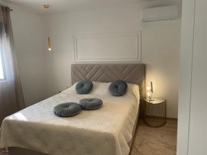 a bed with two blue pillows on top of it at Luxury Villa Olga in Biograd na Moru