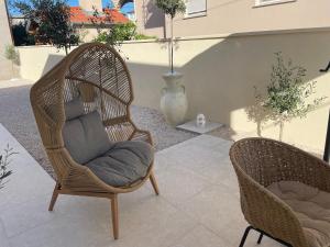 two wicker chairs sitting on a patio at Luxury Villa Olga in Biograd na Moru
