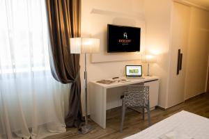 a room with a desk with a computer and a tv at Toscana Ambassador in Poggibonsi