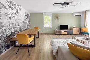 a living room with a dining room table and a couch at T3 Cosy climatisé à Albi avec Terrasse, & Parking in Albi