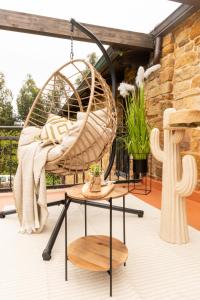 a porch with a rattan chair and a table at Quintana Pidal vistas mar y montaña 
