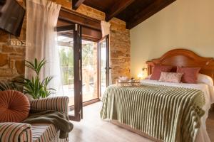 a bedroom with a bed and a sliding glass door at Quintana Pidal vistas mar y montaña 