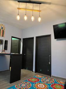 a room with two black doors and a rug on the floor at Discreet luxury in an exclusive area in Matamoros +15 photos