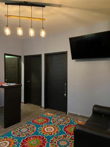 a room with a rug on the floor with two doors at Discreet luxury in an exclusive area in Matamoros