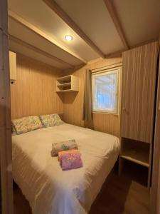 a bedroom with a bed with two pillows on it at Le Chalet du Bonheur in Puget-sur Argens +22 photos