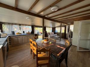 a kitchen and dining room with a table and chairs at Le Chalet du Bonheur in Puget-sur Argens
