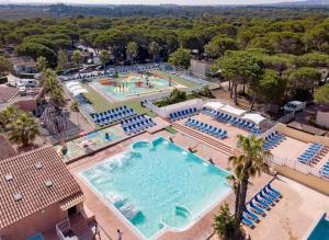 an overhead view of a large swimming pool with blue chairs at Le Chalet du Bonheur in Puget-sur Argens