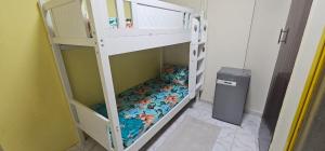 a room with two bunk beds and a trash can at Bedspace in room in Sharjah