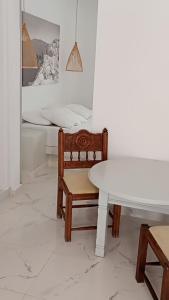 a room with a table and a chair and a bed at Perissa Black Rock Lotus in Perissa