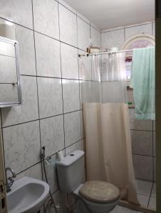 a bathroom with a toilet and a sink and a shower at Casa Faé in Guarapari +16 photos