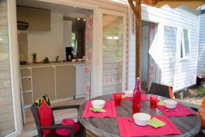 a table with red napkins and red glasses on it at Sélection Camping La Croix -Valmer in La Croix-Valmer