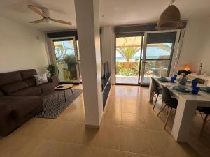 a living room with a couch and a table at Duplex de Zoraida in Roquetas de Mar