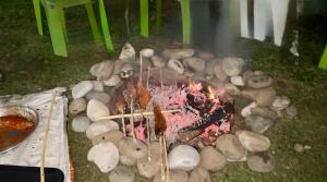 a fire with sticks and rocks on the ground at ROYALE PEAKS villa sonamarg Rd 