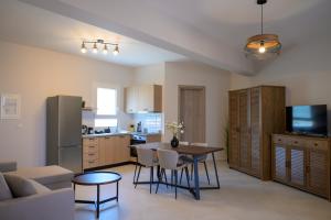a kitchen and living room with a table and chairs at Sotale Suites in Apolpaina