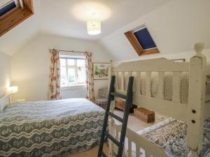 a bedroom with a bunk bed and a window at Uplands Dower House in Ledbury