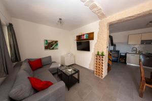 a living room with a couch and a table at Villa BiBo in Linardići