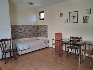 a bedroom with a bed and a table and chairs at Rajj in Bela Crkva +5 photos