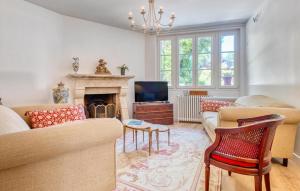a living room with a couch and a fireplace at Charmante Maison Avec Piscine in Savignac-les-Églises