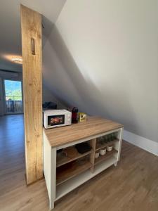 a room with a table with a microwave on it at Apartma Klemenc in Bohinj