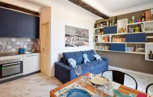 a living room with a blue couch and a table at Nice Apartment In Sestri Levante in Sestri Levante