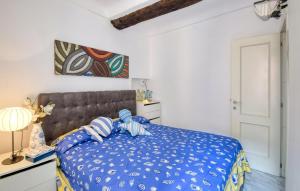 a bedroom with a bed with a blue comforter at Nice Apartment In Sestri Levante in Sestri Levante