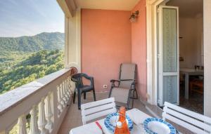 a balcony with a table and chairs and a view at 2 Bedroom Awesome Apartment In Terrile in Uscio