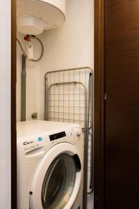a washer and dryer in a small room at Air conditioned apartment, 3 min walk to the beaches, Garage in Antibes