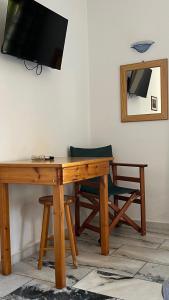 a wooden table with a television and a chair at Proavlio in Moutsoúna