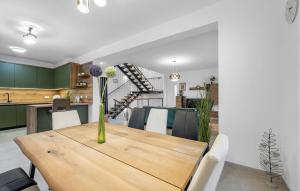 a kitchen and dining room with a wooden table and chairs at Awesome Home In Murter in Murter