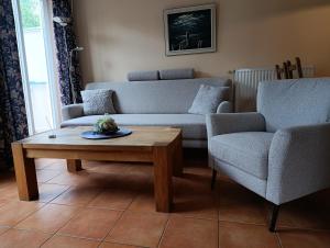 a living room with a couch and a table and chairs at Störtebeker 07 in Kühlungsborn