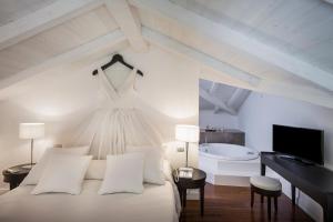 a bedroom with a bed with a dress hanging on the wall at Hotel Villa Fanny in Cagliari