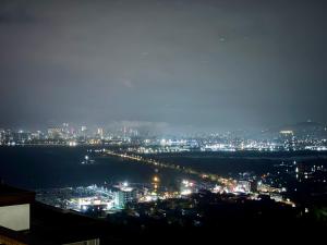 a view of a city at night with lights at Laia Hotel House in Itʼkhvisi