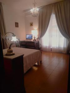 a bedroom with a bed and a table with a lamp at Casa in villa nel Parco del Vesuvio in Pollena Trocchia