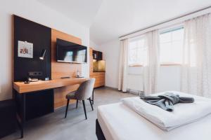 Postel nebo postele na pokoji v ubytování Ambienthotel Tassilo