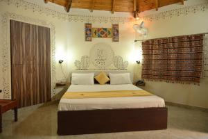 a bedroom with a large bed in a room at Shyam Homestay in Bhuj