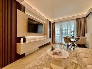 a living room with a couch and a table at Bucharest Cortina North in Voluntari
