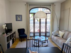 a living room with a couch and a table at T3 Astoria Grand Lac hyper centre in Aix-les-Bains