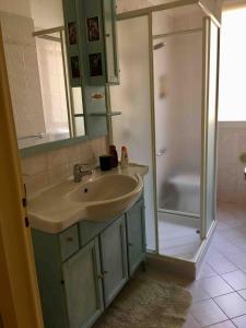 a bathroom with a sink and a shower at In the center of Modena, Piazza Roma and the Ferrari Museum in Modena +12 photos