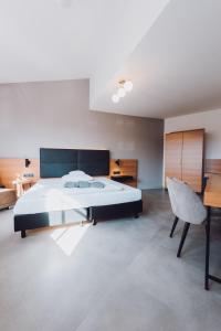 Postel nebo postele na pokoji v ubytování Ambienthotel Tassilo